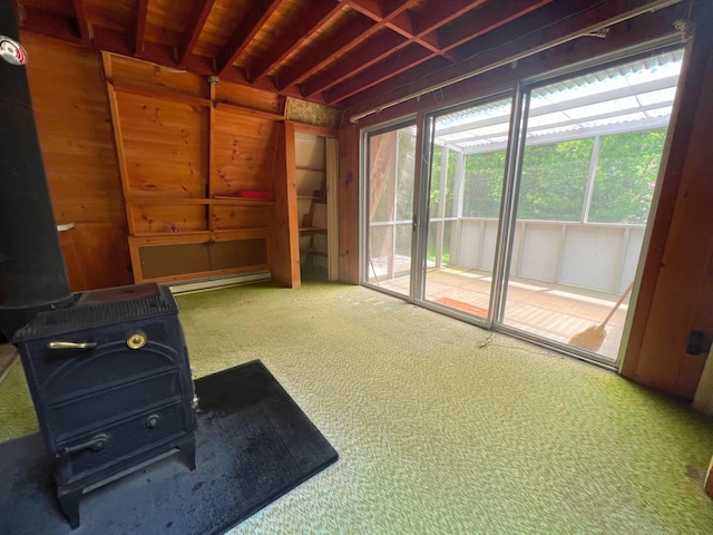 20 Lemeuls Rd, Bristol, ME 04558 - miscellaneous room with a wood stove, carpet flooring, and wooden walls