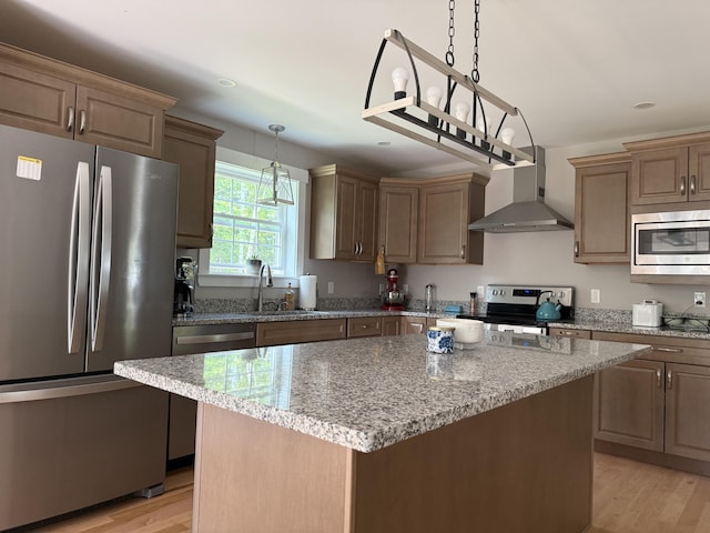 34 May Way, Sidney, ME 04330 - kitchen featuring appliances with stainless steel finishes, wall chimney exhaust hood, light wood-style floors, light stone counters, and recessed lighting