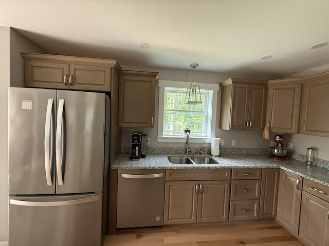 34 May Way, Sidney, ME 04330 - kitchen featuring stainless steel appliances, light wood finished floors, light stone countertops, and hanging light fixtures