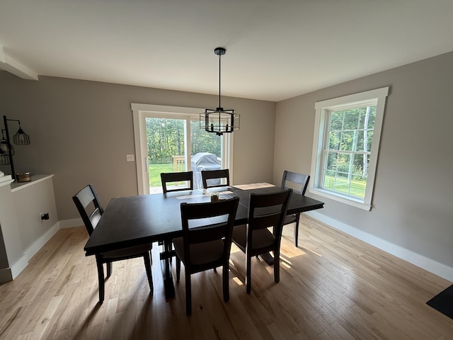 34 May Way, Sidney, ME 04330 - dining area with a chandelier, plenty of natural light, and light wood finished floors
