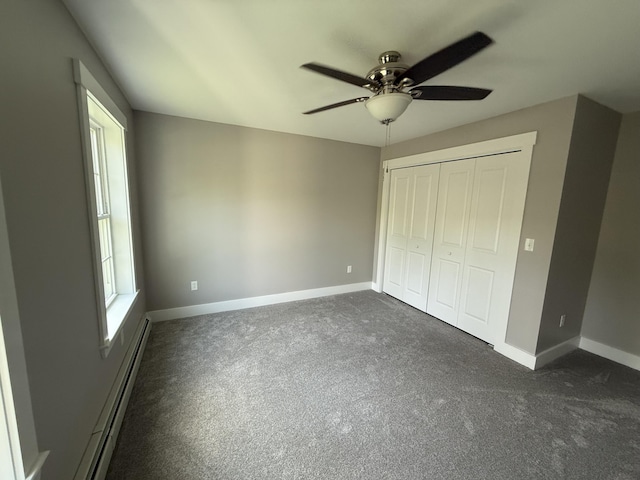 34 May Way, Sidney, ME 04330 - unfurnished bedroom with a baseboard heating unit, dark carpet, a closet, and ceiling fan
