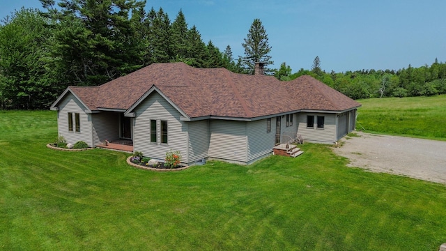 32 Ridge Rd, Marshfield, ME 04654 - view of front of house featuring roof with shingles, a front yard, and a chimney