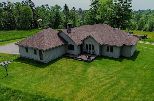 32 Ridge Rd, Marshfield, ME 04654 - back of house featuring a lawn, a chimney, a shingled roof, and a deck