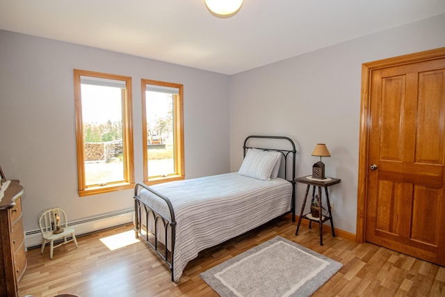 32 Ridge Rd, Marshfield, ME 04654 - bedroom with a baseboard radiator and light wood-style floors