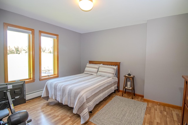 32 Ridge Rd, Marshfield, ME 04654 - bedroom featuring a baseboard heating unit and light wood-type flooring