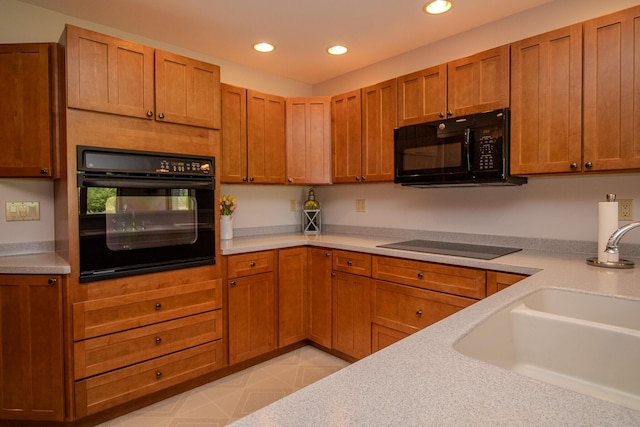 32 Ridge Rd, Marshfield, ME 04654 - kitchen with black appliances, recessed lighting, light countertops, and brown cabinetry