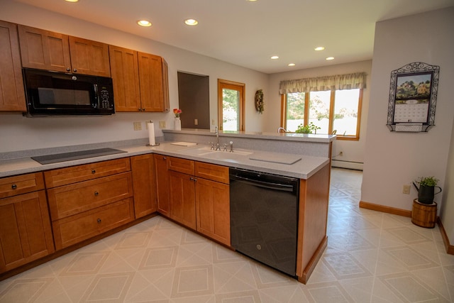 32 Ridge Rd, Marshfield, ME 04654 - kitchen with black appliances, a peninsula, brown cabinets, recessed lighting, and a baseboard radiator