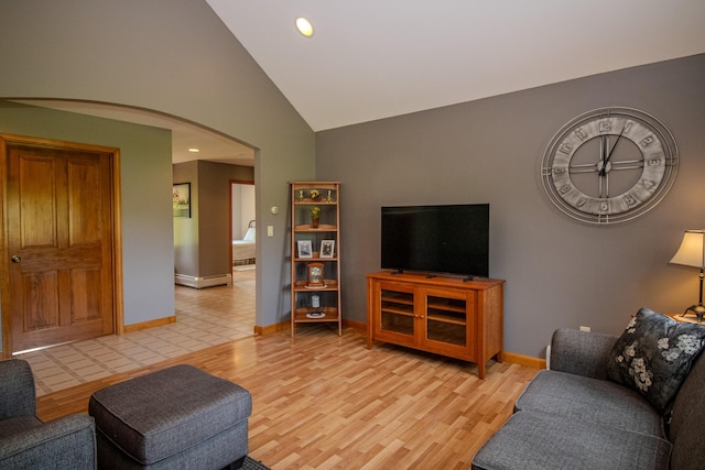 32 Ridge Rd, Marshfield, ME 04654 - living room featuring arched walkways, light wood finished floors, vaulted ceiling, and recessed lighting
