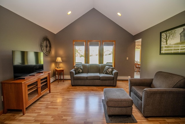 32 Ridge Rd, Marshfield, ME 04654 - living area featuring a baseboard radiator, healthy amount of natural light, light wood finished floors, recessed lighting, and high vaulted ceiling