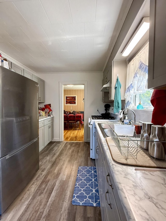 755 Main St, Calais, ME 04619 - kitchen featuring freestanding refrigerator, white range with gas cooktop, gray cabinets, and wood finished floors