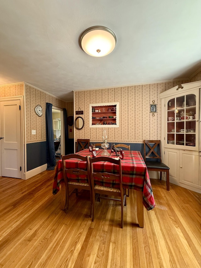 755 Main St, Calais, ME 04619 - dining space featuring wallpapered walls, light wood finished floors, and a wainscoted wall