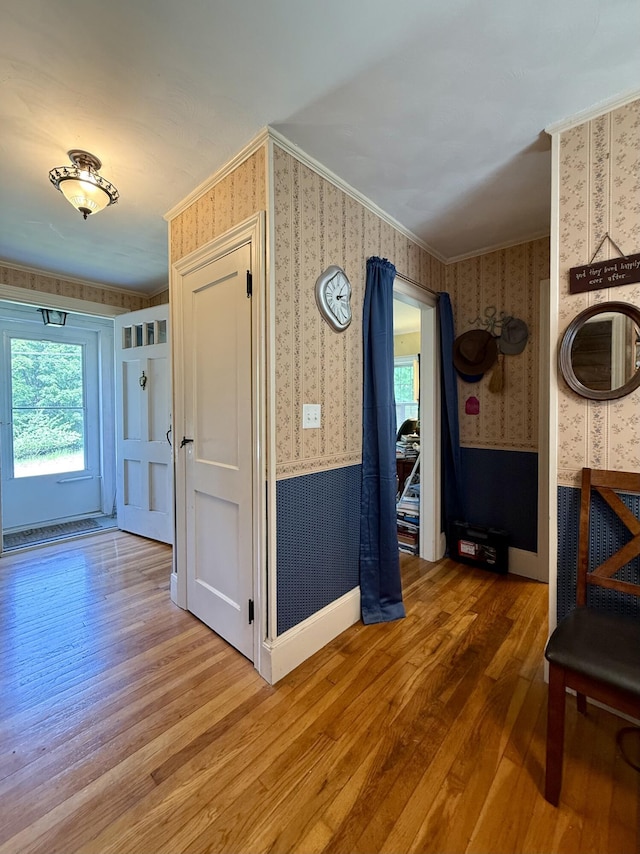 755 Main St, Calais, ME 04619 - hall featuring wallpapered walls, healthy amount of natural light, wood finished floors, a wainscoted wall, and crown molding