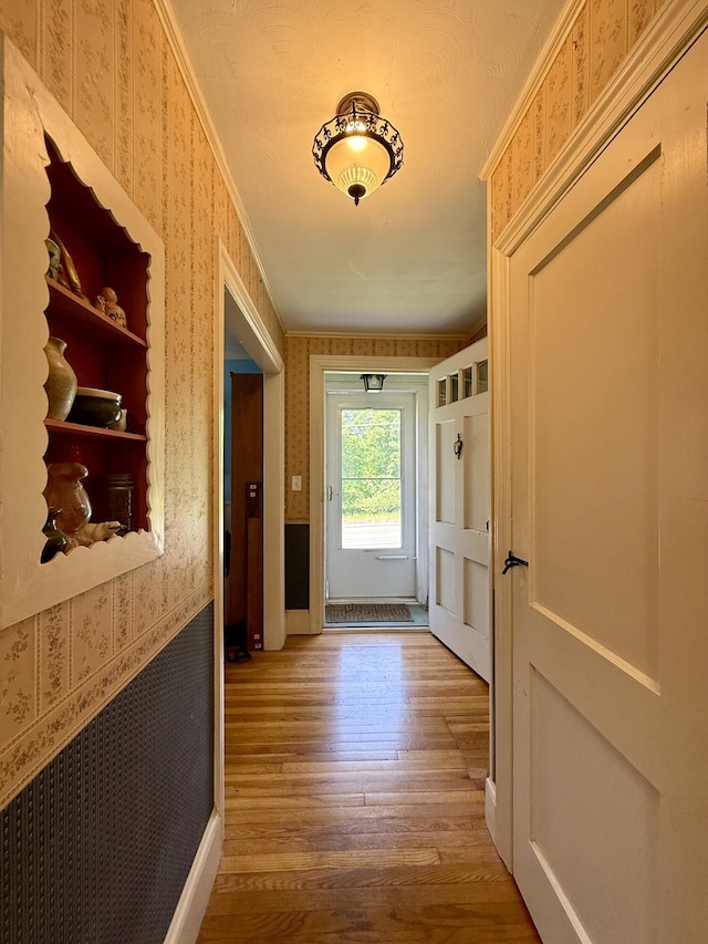 755 Main St, Calais, ME 04619 - doorway featuring wallpapered walls, wood finished floors, radiator heating unit, and crown molding