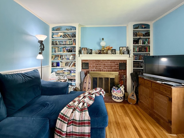 755 Main St, Calais, ME 04619 - living area featuring built in shelves, wood finished floors, ornamental molding, and a brick fireplace