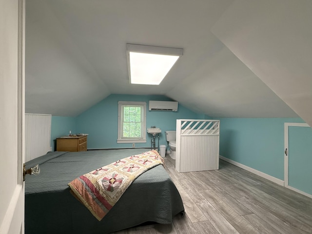 755 Main St, Calais, ME 04619 - bedroom with an AC wall unit, wood finished floors, and vaulted ceiling