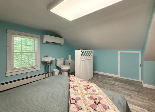 755 Main St, Calais, ME 04619 - bedroom featuring an AC wall unit, lofted ceiling, wood finished floors, and baseboard heating