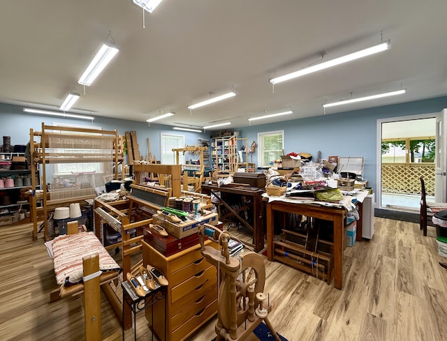 755 Main St, Calais, ME 04619 - office area featuring wood finished floors, a workshop area, and healthy amount of natural light