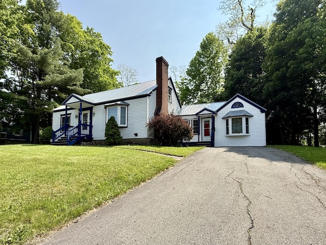 755 Main St, Calais, ME 04619 - single story home with asphalt driveway, a chimney, a front yard, and a metal roof