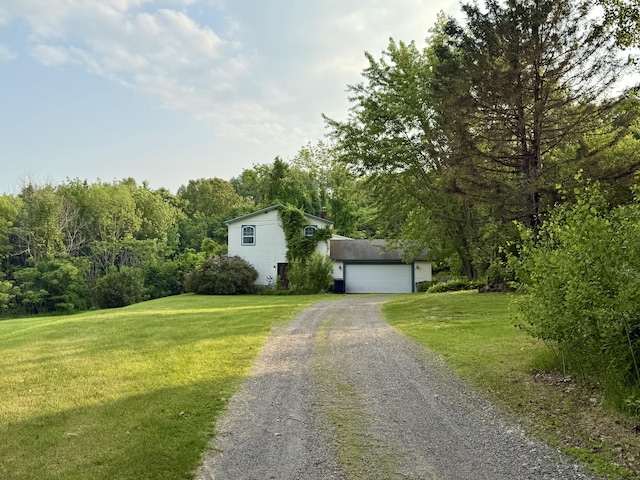 211 Hinckley Hill Rd, Carmel, ME 04419 - view of front of home featuring gravel driveway, a garage, and a front lawn