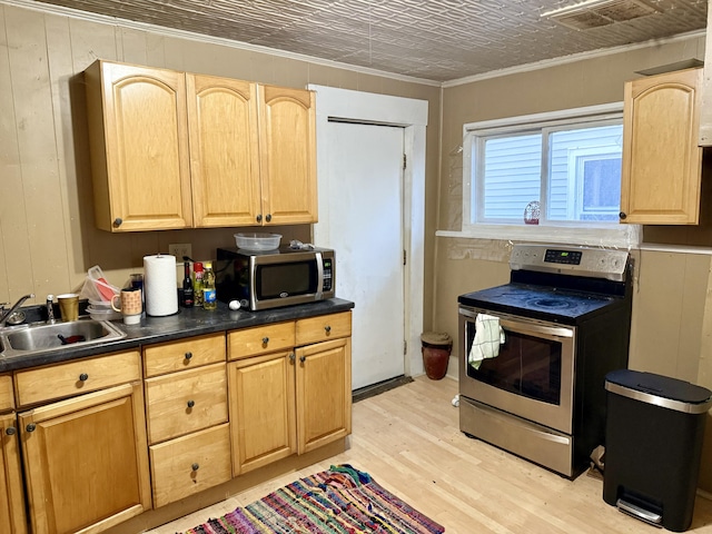 58 Elm St, Old Town, ME 04468 - kitchen featuring stainless steel appliances, ornamental molding, light wood-style flooring, light brown cabinetry, and dark countertops