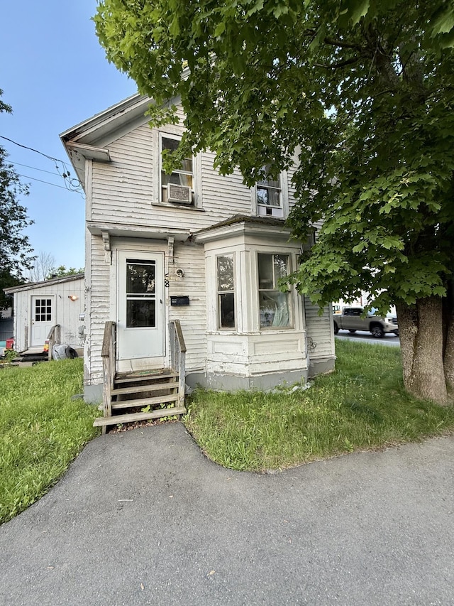 58 Elm St, Old Town, ME 04468 - view of front facade featuring entry steps and cooling unit