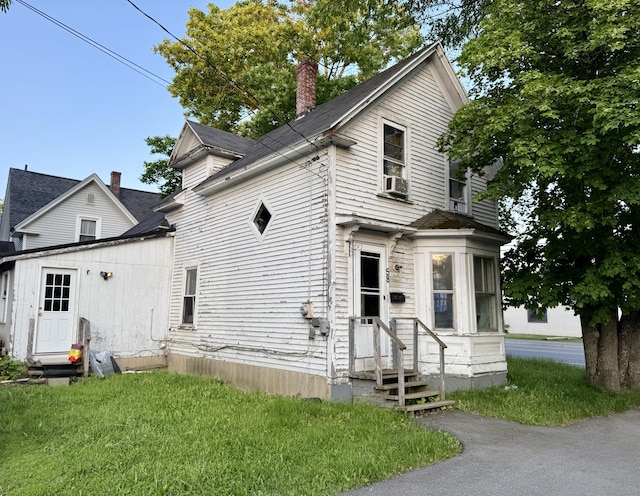 58 Elm St, Old Town, ME 04468 - view of front of property featuring entry steps, a chimney, cooling unit, and a front lawn
