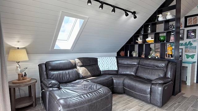 552 Port Rd, Machiasport, ME 04655 - living area with track lighting, a skylight, lofted ceiling, and wood finished floors