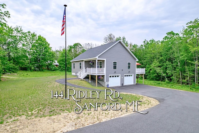 144 Ridley Rd, Sanford, ME 04073 - view of front of home with driveway, a garage, a front yard, and stairs