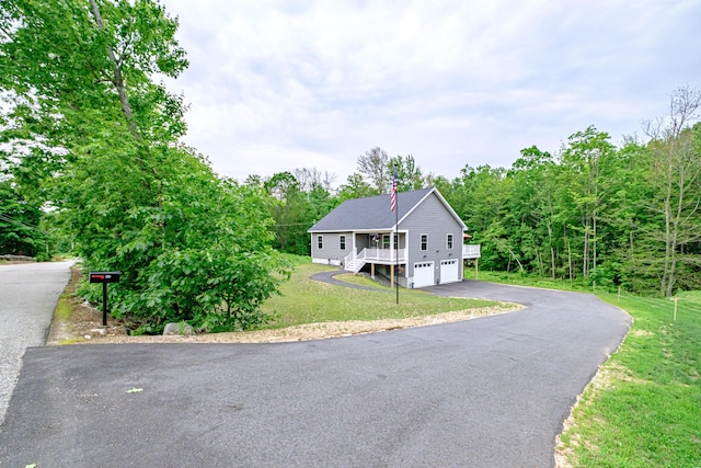 144 Ridley Rd, Sanford, ME 04073 - view of front facade with asphalt driveway, a garage, a front lawn, and stairs
