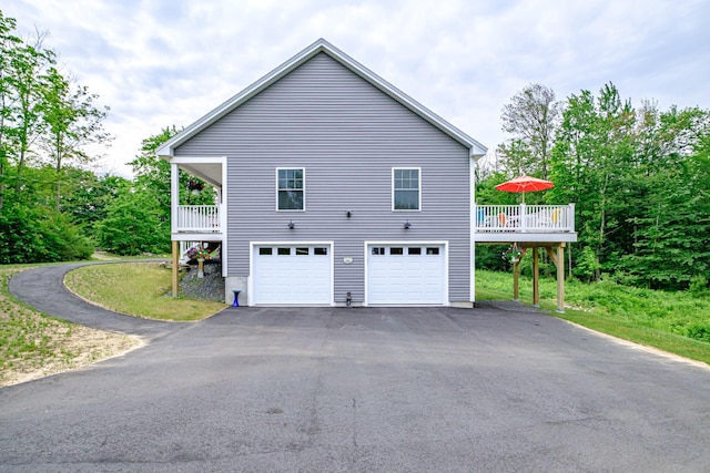 144 Ridley Rd, Sanford, ME 04073 - view of property exterior with asphalt driveway, an attached garage, and a wooden deck