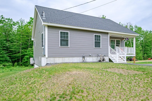 144 Ridley Rd, Sanford, ME 04073 - view of side of home featuring a porch, a lawn, and a shingled roof
