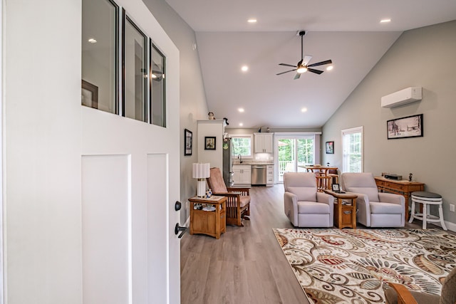 144 Ridley Rd, Sanford, ME 04073 - living area featuring high vaulted ceiling, a wall unit AC, light wood finished floors, a ceiling fan, and recessed lighting