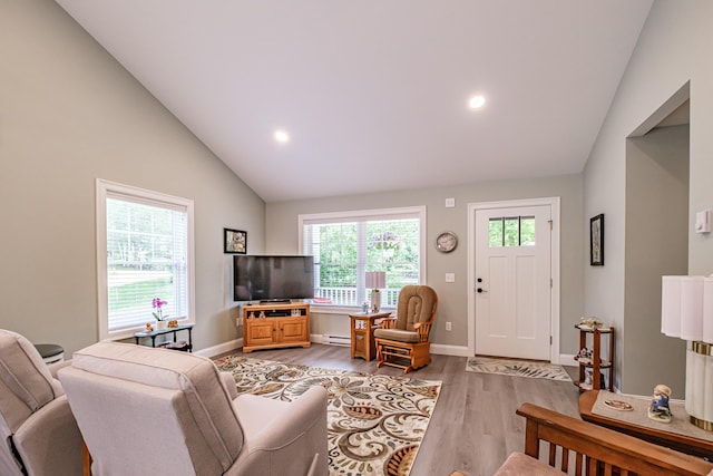 144 Ridley Rd, Sanford, ME 04073 - living room with plenty of natural light, light wood-type flooring, lofted ceiling, a baseboard radiator, and recessed lighting