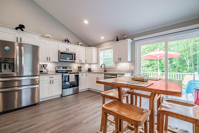 144 Ridley Rd, Sanford, ME 04073 - kitchen featuring appliances with stainless steel finishes, white cabinets, light stone counters, light wood finished floors, and recessed lighting