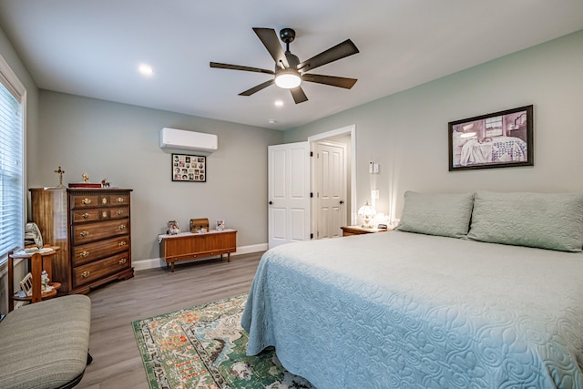 144 Ridley Rd, Sanford, ME 04073 - bedroom with a wall mounted AC, wood finished floors, ceiling fan, and recessed lighting