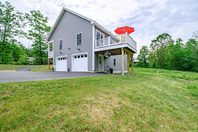 144 Ridley Rd, Sanford, ME 04073 - view of property exterior with an attached garage, asphalt driveway, a lawn, and a wooden deck