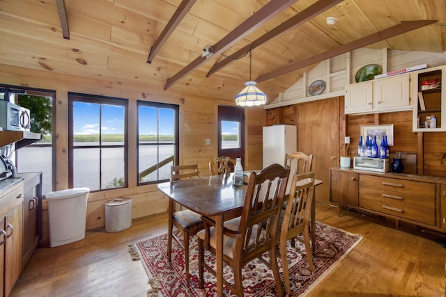 19 Davis Ln, Burnham, ME 04922 - dining area featuring wood ceiling, light wood-style flooring, wooden walls, and a water view