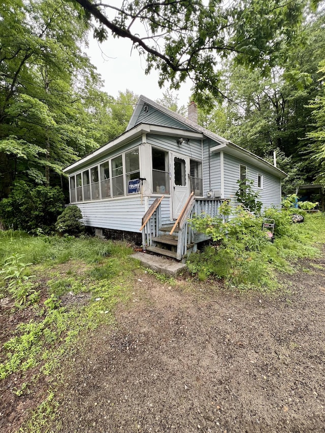 358 Swain Rd, Rumford, ME 04276 - shotgun-style home with a chimney and a sunroom