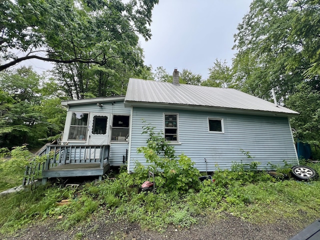 358 Swain Rd, Rumford, ME 04276 - view of side of property with a sunroom, a metal roof, and a chimney