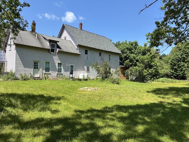 6 Paddy Ln, Franklin, ME 04634 - back of house featuring a yard and a chimney