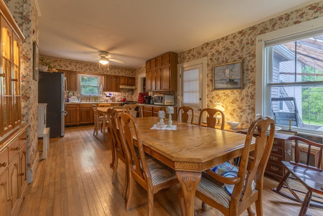6 Paddy Ln, Franklin, ME 04634 - dining space with wallpapered walls, light wood-style flooring, and a ceiling fan