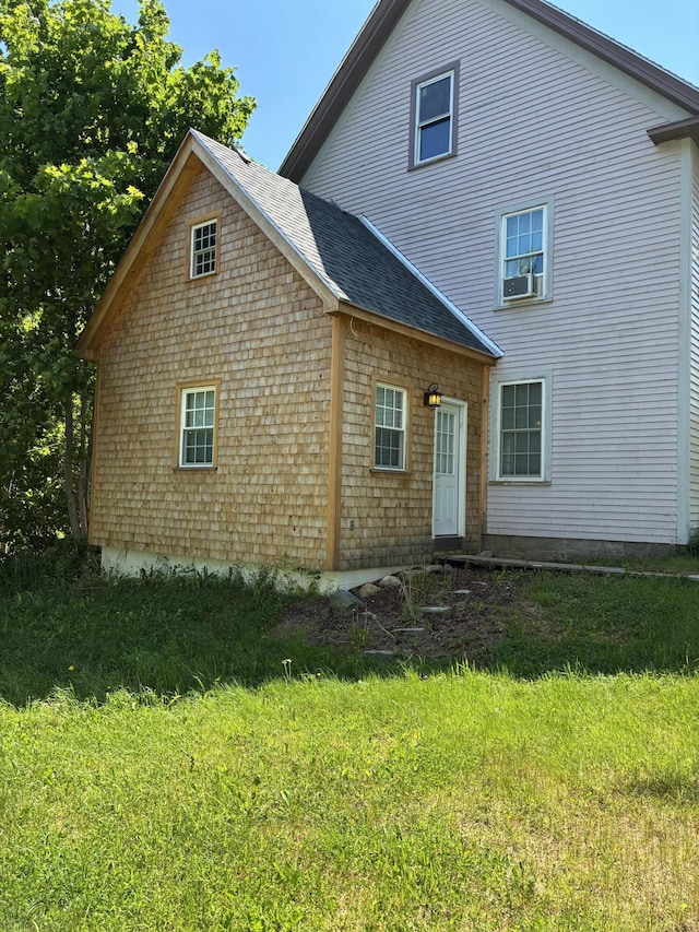 6 Paddy Ln, Franklin, ME 04634 - back of property featuring a yard, a shingled roof, and cooling unit