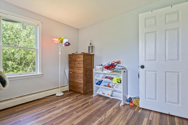 104 Chick Rd, Lebanon, ME 04027 - bedroom featuring a baseboard heating unit and wood finished floors