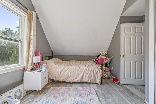 104 Chick Rd, Lebanon, ME 04027 - bedroom with multiple windows, lofted ceiling, and wood finished floors