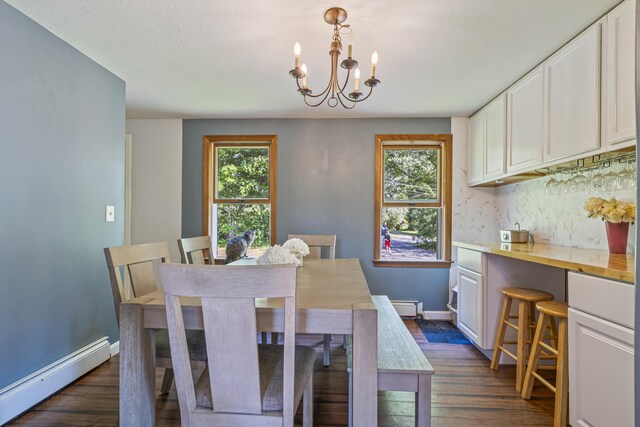 104 Chick Rd, Lebanon, ME 04027 - dining area with baseboard heating, a chandelier, and dark wood-type flooring