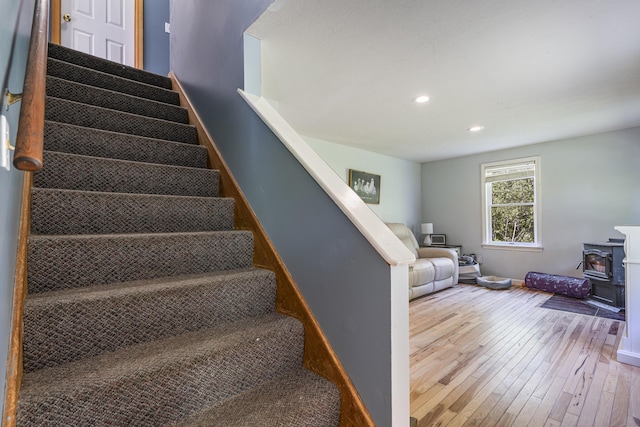 104 Chick Rd, Lebanon, ME 04027 - staircase featuring a wood stove, hardwood / wood-style flooring, and recessed lighting