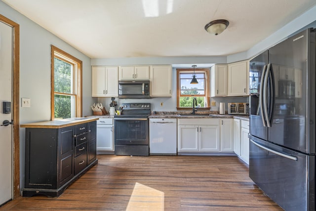 104 Chick Rd, Lebanon, ME 04027 - kitchen with stainless steel appliances, pendant lighting, dark wood-style floors, and white cabinets