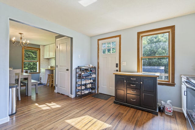 104 Chick Rd, Lebanon, ME 04027 - kitchen with dark wood-style flooring, a chandelier, light countertops, and healthy amount of natural light
