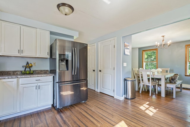 104 Chick Rd, Lebanon, ME 04027 - kitchen with stainless steel fridge with ice dispenser, dark wood-style flooring, white cabinets, a chandelier, and dark stone counters