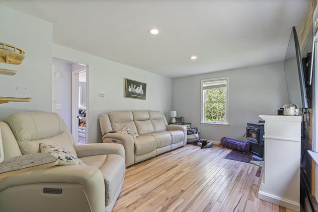 104 Chick Rd, Lebanon, ME 04027 - living room featuring a wood stove, light wood-style floors, and recessed lighting